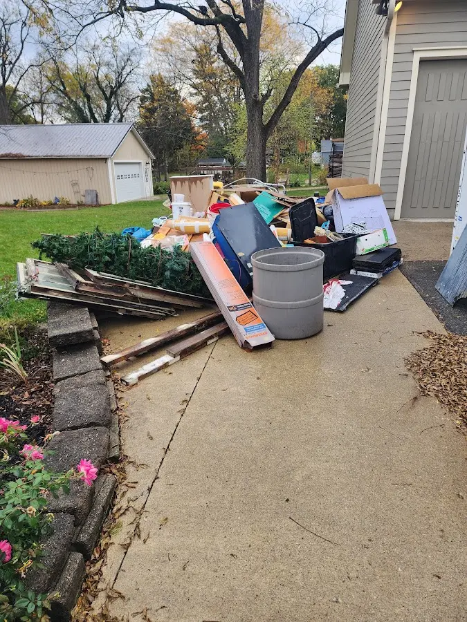Dumpster being loaded with debris for Residential Dumpster Rental in Circle D-KC Estates